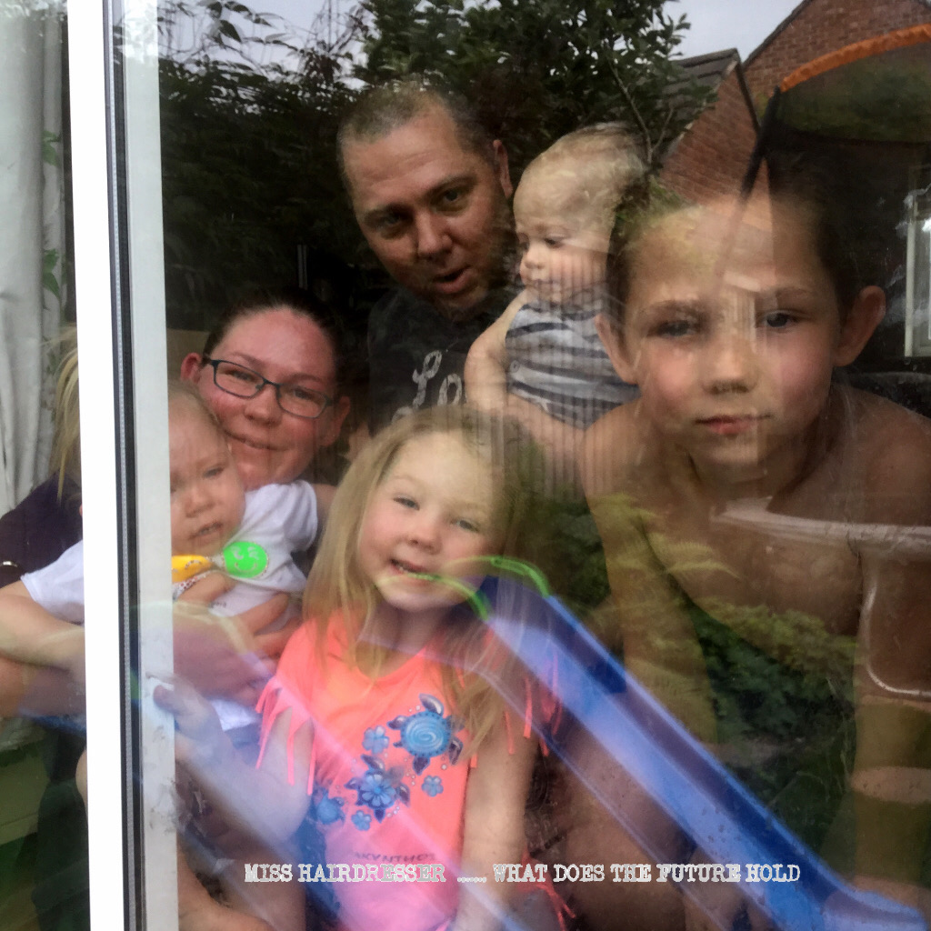 Family on the inside of a window
