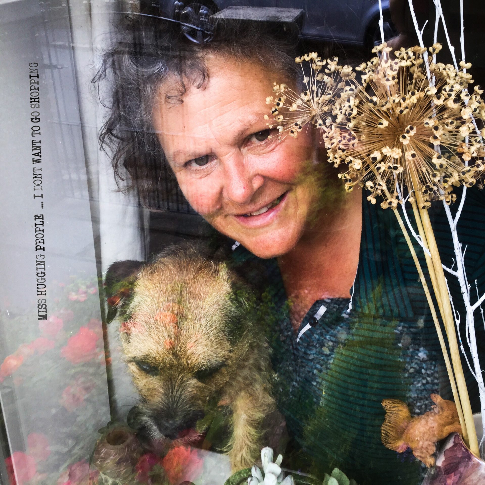 Person with dog behind a window